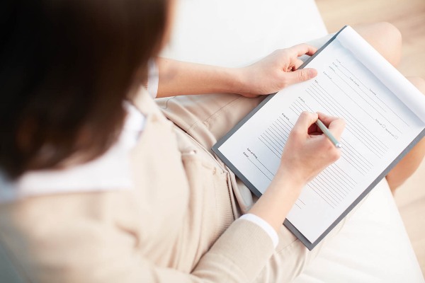 woman filling out finance forms woman filling out finance forms